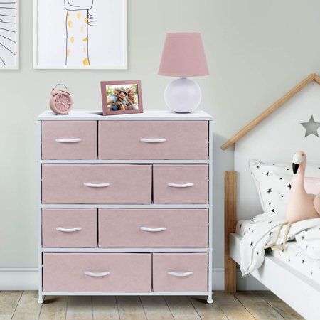 a pink chest of drawers in a child's bedroom