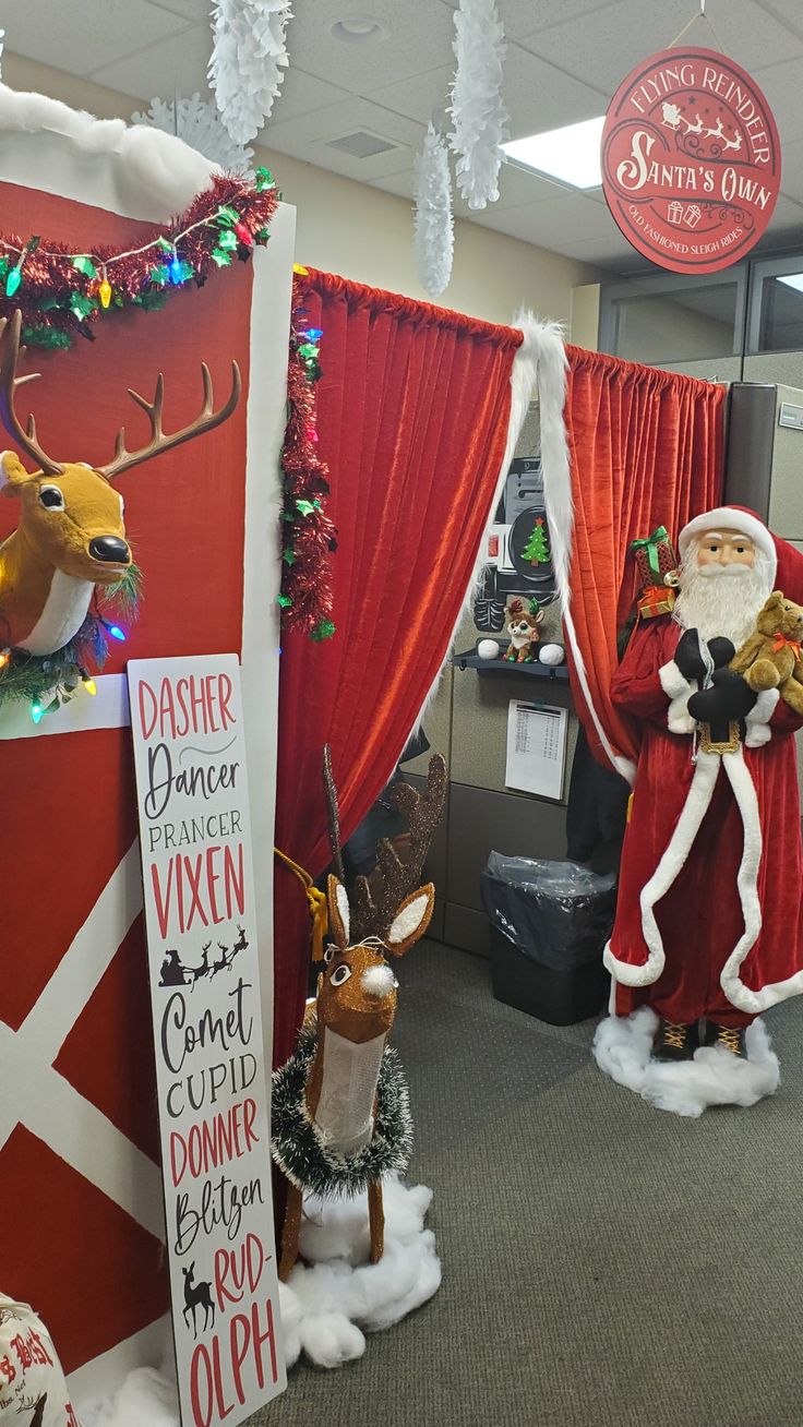 christmas decorations in an office cubicle decorated with santa and reindeer