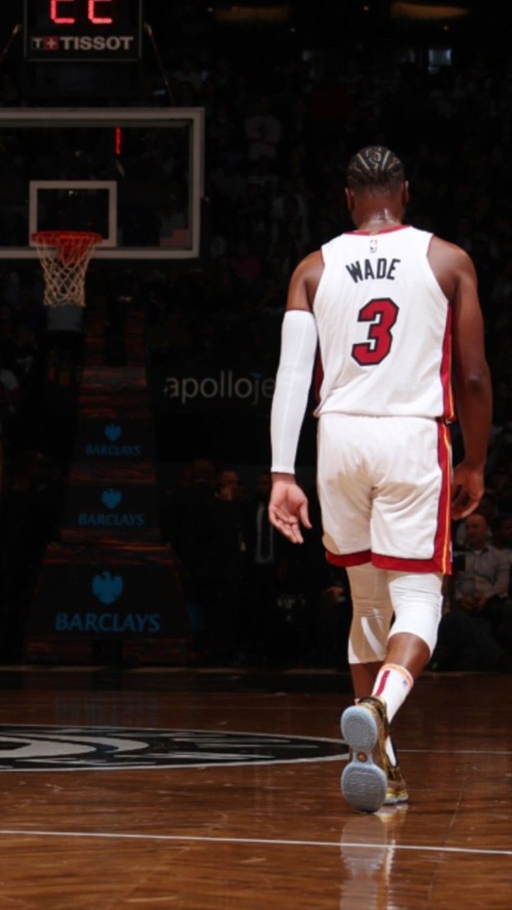 a basketball player dribbling the ball down the court