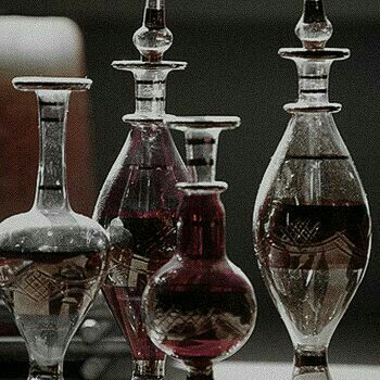 three glass vases sitting next to each other on a table