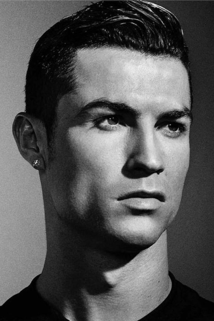 a black and white photo of a young man with short hair wearing a polo shirt