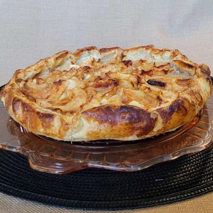 a pie sitting on top of a glass platter