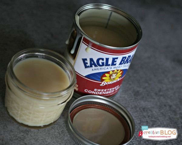 an open can of eagle brand butter next to a jar of condiments on the floor