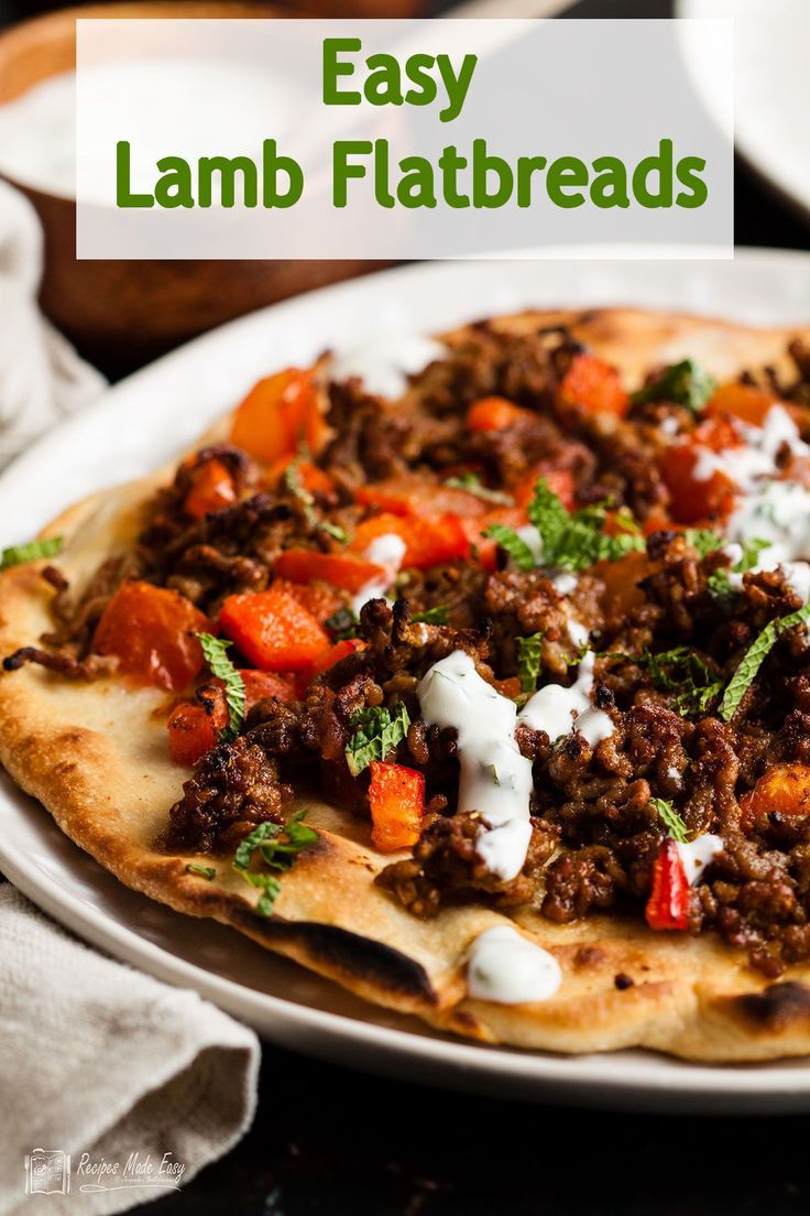 an easy lamb flatbread is topped with sour cream and fresh herbs for a tasty meal