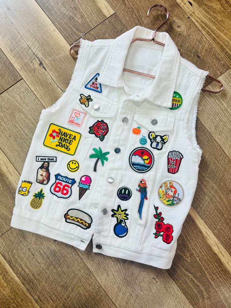 White denim vest with the cutest patches ever! One of a kind ... Fits like a small/medium White Fitted Denim Vest, White Denim Vest For Summer, Casual White Patchwork Vest, Casual White Sleeveless Denim Vest, White Patchwork Sleeveless Vest, Trendy White Denim Vest With Pockets, White Sleeveless Patchwork Vest, Trendy White Spring Vest, White Sleeveless Denim Vest For Summer