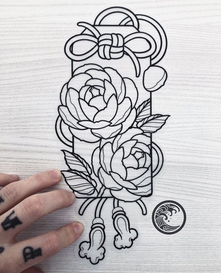 a person holding up a drawing with flowers on it