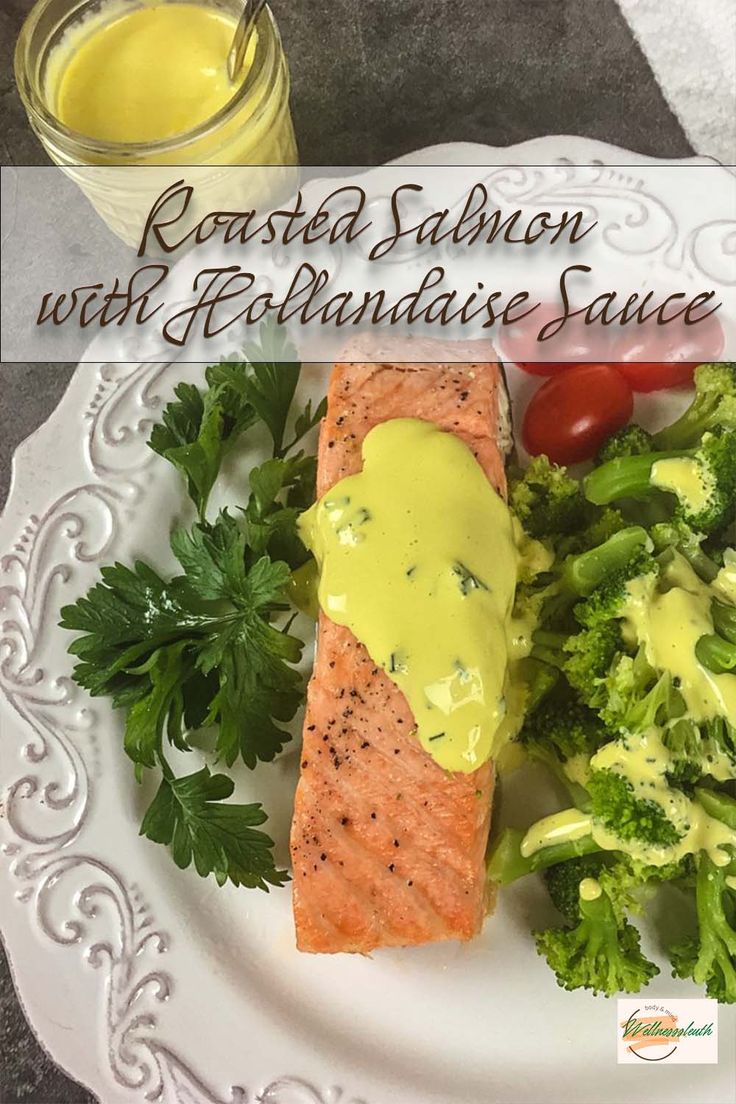 a white plate topped with salmon and broccoli next to a jar of mustard