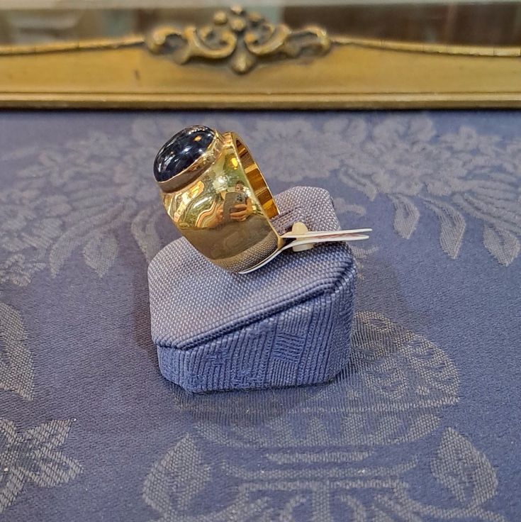 This Ring in 18k Gold with an Iolite makes a beautiful addition to any jewelry collection. The warm color of the 18k gold holds the mesmerizing Iolite for a stunning contrast. A true show stopper, this beautiful and unique ring is sure to turn heads. Elegant Gold Rings With Tanzanite, Elegant Gold Tanzanite Rings, Formal Gold Amethyst Ring With Bezel Setting, Luxury Tanzanite Yellow Gold Ring, Luxury Yellow Gold Tanzanite Ring, Timeless Gold Sapphire Ring, Timeless Gold Amethyst Ring, Gold Tanzanite Round Rings, Gold Tanzanite Gemstone Rings