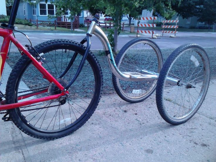 two bikes parked next to each other on the sidewalk