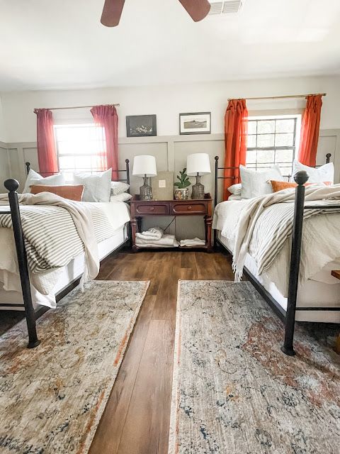 two beds in a room with wooden floors