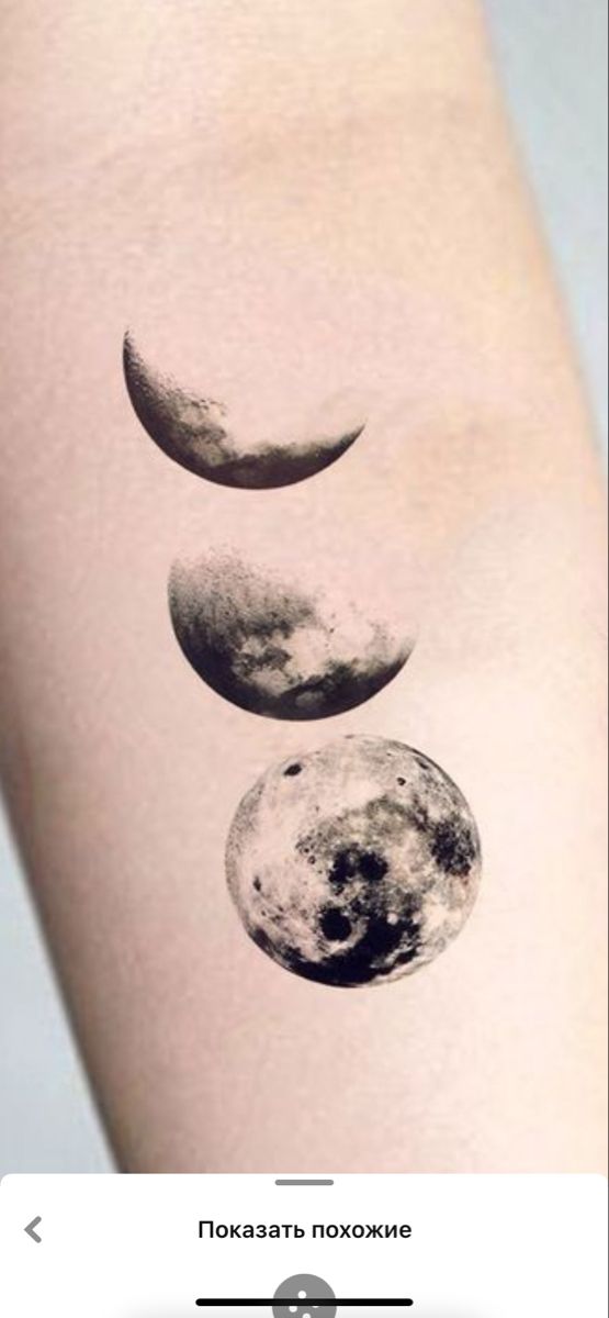 three phases of the moon tattoo on someone's left arm, with text below it