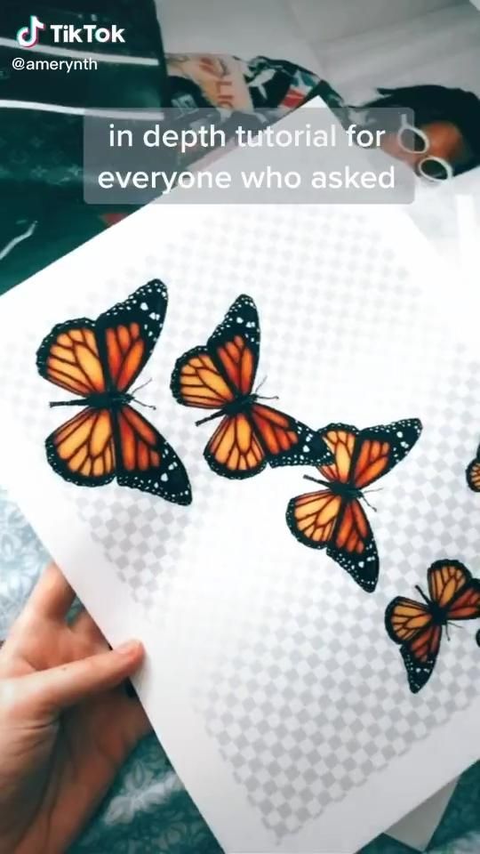 a person holding up a piece of paper with three butterflies on it and the words in depth