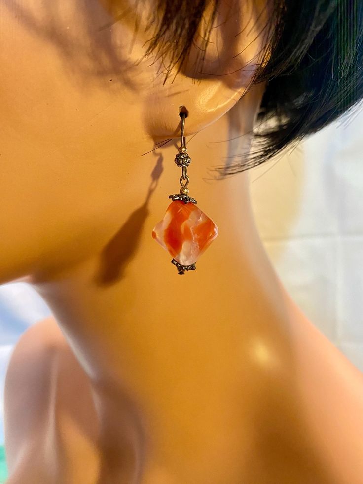 These "Carnelian" earrings are handmade. The earrings are made out of carnelian, chrome plates, beads and charms. We usually ship packages within 1-2 business days and you will receive an email notification when we ship your package. Depending on your location, our shipping time takes about 4-5 business days. Thank you for your support and have a wonderful day! :3 HAVE QUESTIONS? Please don't hesitate to reach out! 😊 Orange Carnelian Earrings For Gift, Orange Carnelian Dangle Earrings, Carnelian Dangle Earrings With Natural Stones, Carnelian Natural Stones Dangle Earrings, Amber Carnelian Earrings With Ear Wire, Handmade Carnelian Orange Earrings, Red Agate Earrings For Gift, Red Agate Earrings As Gift, Handmade Orange Carnelian Earrings