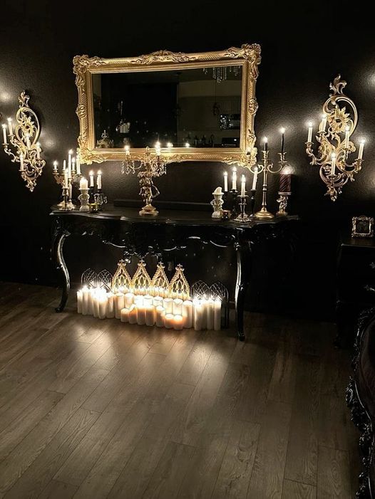 a table with candles and a mirror on it