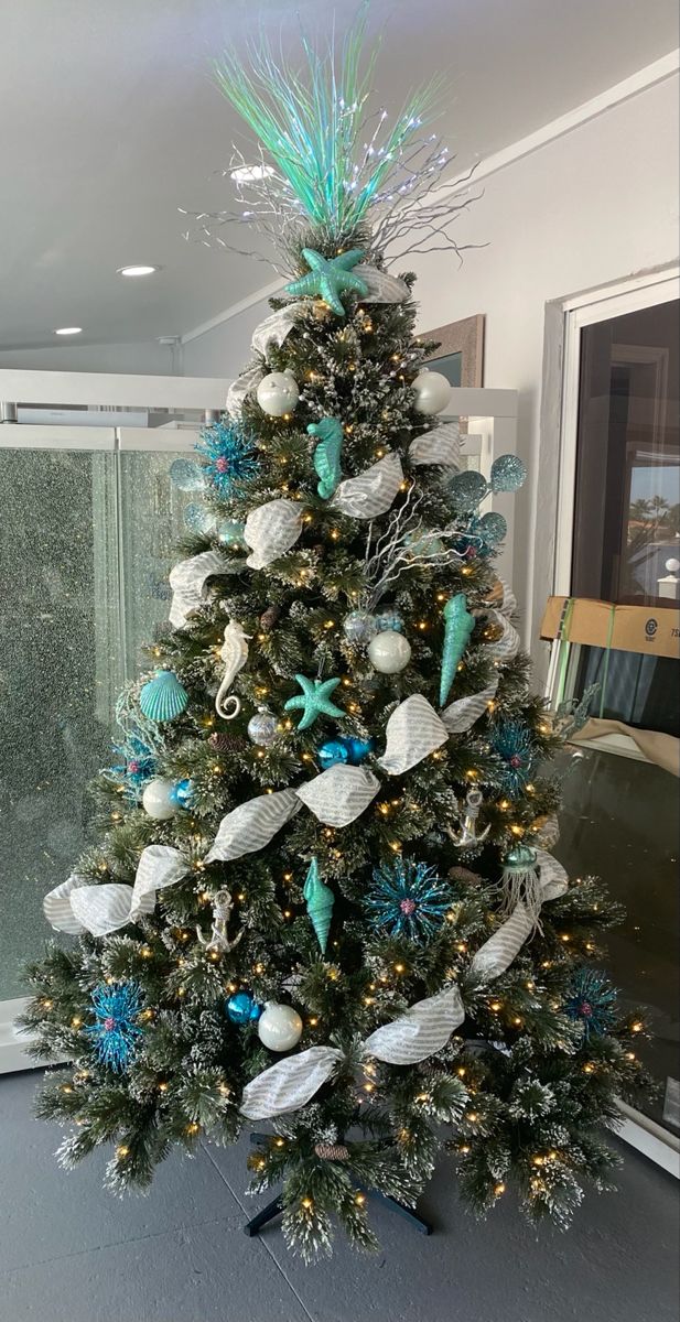 a christmas tree decorated with blue and white ornaments