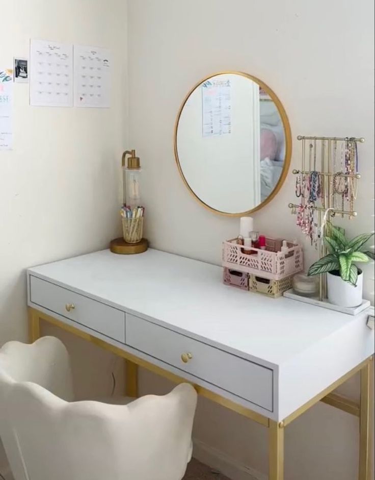 a white desk with a mirror, chair and potted plant on top of it