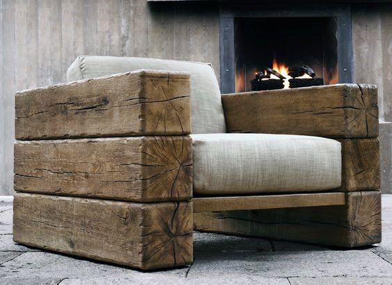 a chair made out of wood sitting in front of a fire place