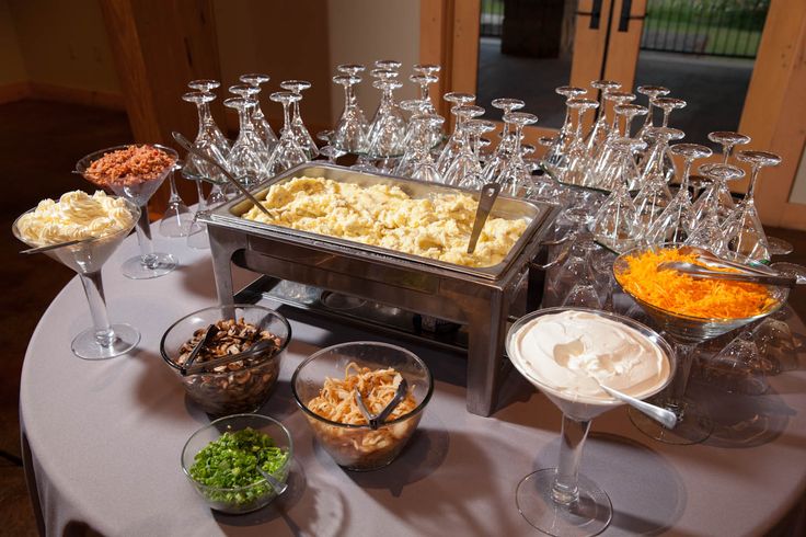 an assortment of food and wine glasses on a table