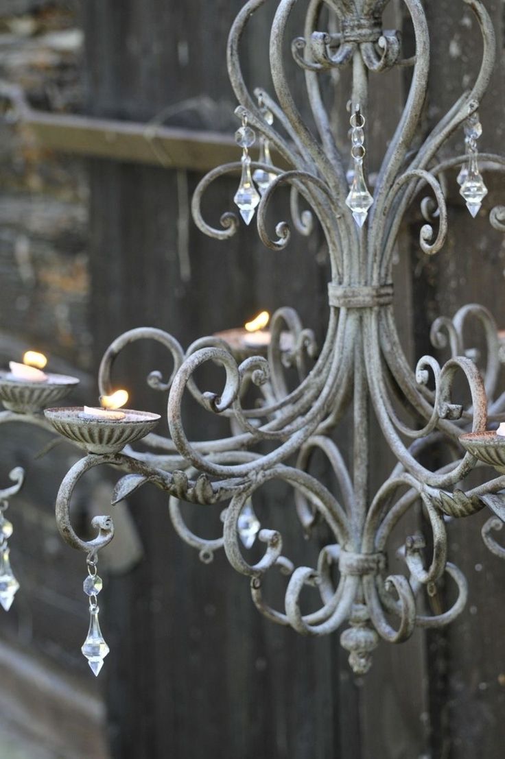 an ornate chandelier with candles lit inside