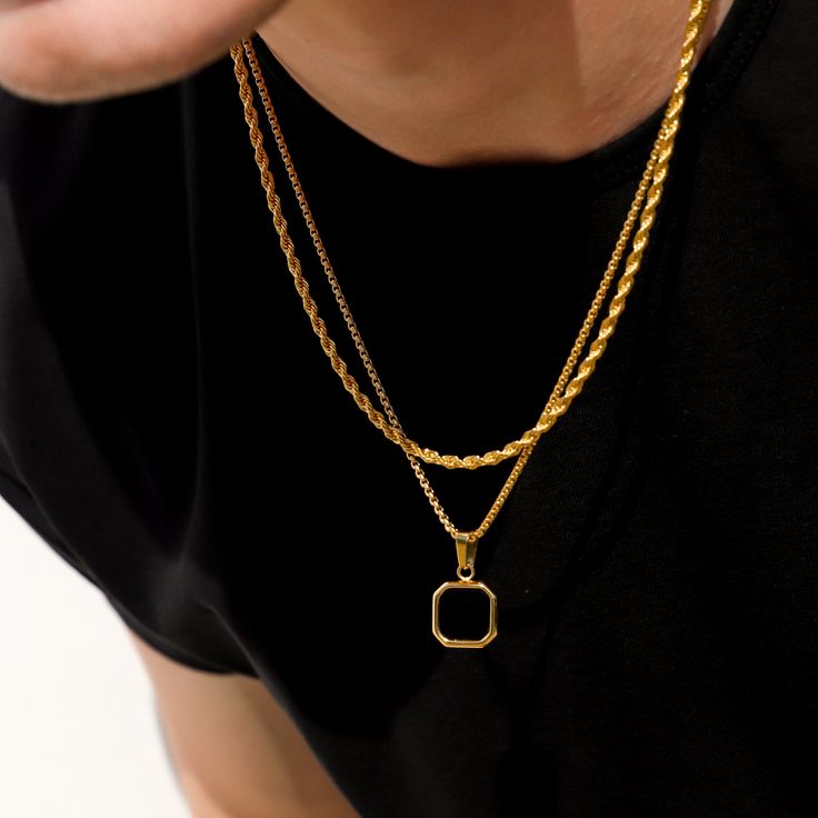 The black onyx pendant on a gold round box chain is a striking and sophisticated piece of jewelry. The pendant showcases a sleek and polished black imitation onyx stone, renowned for its deep black color and smooth surface. The stone is expertly set in a luxurious gold bezel, accentuating its elegance and creating a captivating contrast. The pendant gracefully hangs from a gold round box chain, featuring interconnected square links that lend a modern and stylish appearance. The chain perfectly c Black Rope Chain Necklace As Gift, Elegant Black Box Chain Necklace, Elegant Black Rope Chain Necklace, Black Round Pendant Necklace, Gold Plated, Black Round Pendant Necklace In Gold Plated, Gold Onyx Pendant Jewelry, Black Gold Plated Round Pendant Necklace, Black Pendant Chain Necklace, Tarnish Resistant, Gold Onyx Round Pendant Jewelry