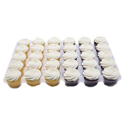 cupcakes with white frosting are arranged in rows