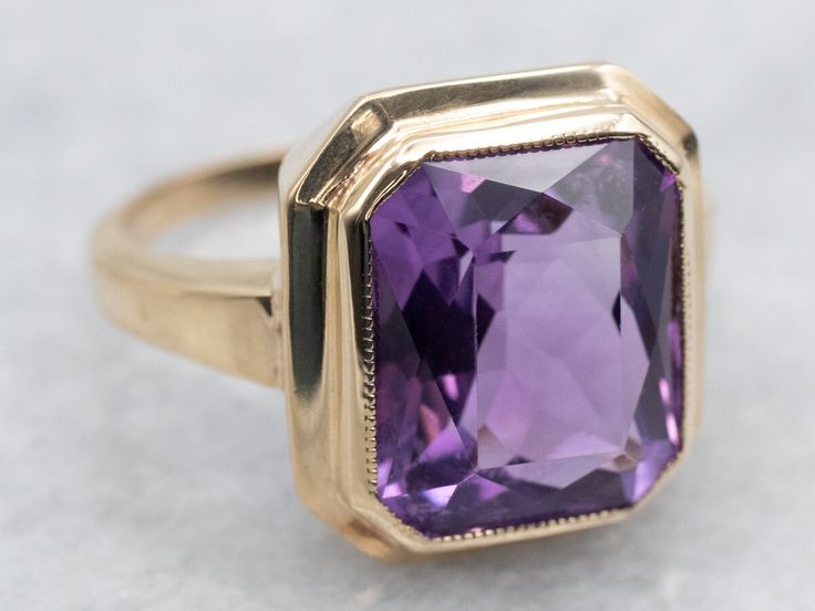 Indulge in luxury with this ring! The bezel setting showcases the stunning emerald cut amethyst, creating a sophisticated and elegant look. Elevate your style and embrace the exclusivity of this solitaire ring. Metal: 10K Yellow Gold Gem: Amethyst 5.68 Carats Gem Measurements: 10.1 x 11.9 mm, Emerald Cut Ring Size: 5.50 Marks: "10K<>" Stamped on the inside band SKU #: A37623 Each piece has been identified and graded by a Graduate Gemologist who has been certified by the Gemological Institute of America (GIA). We have six brick-and-mortar storefronts in Maine, Massachusetts, and New Hampshire and have been in business for over 25 years! Please visit our Shop's About Page or our website for more information about our jewelry. For questions about diamond grading, we recommend the  Gemological Right Hand Ring, Emerald Cut Rings, Pocket Watch Chain, Right Hand Rings, Hand Ring, Ring Metal, Amethyst Ring, Pearl Pendant, New Hampshire