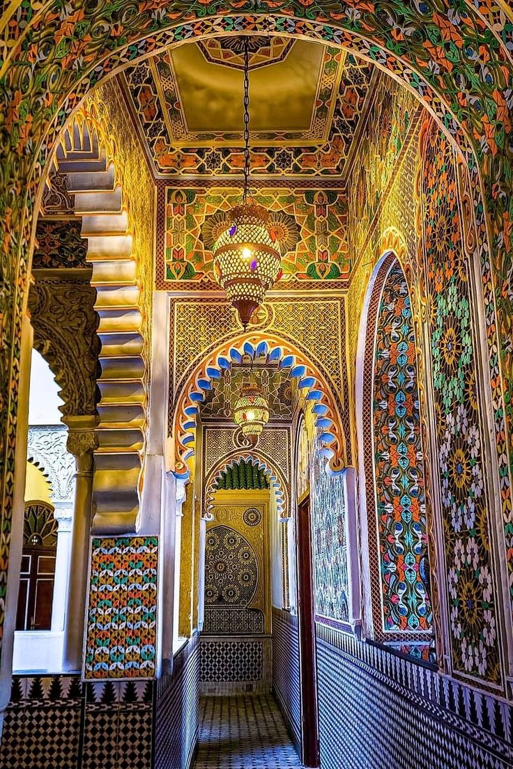 an ornate building with many colorful designs on the walls