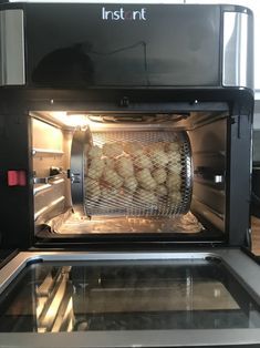 an open microwave oven with food cooking in it