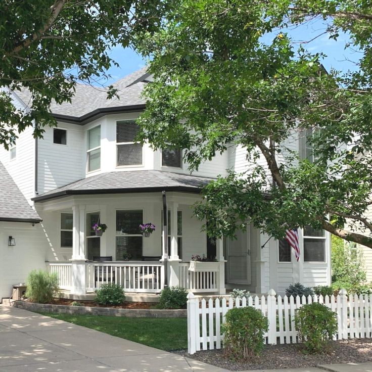 a white house with a picket fence in front of it