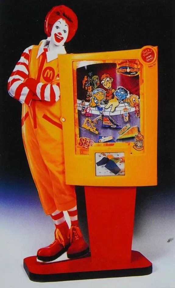 a clown standing in front of a game machine