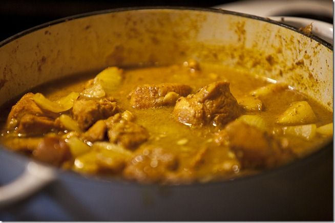 a pot filled with stew sitting on top of a stove