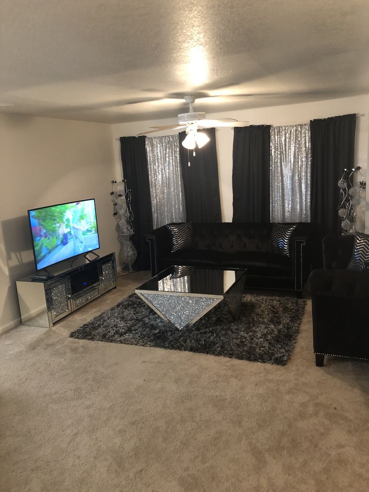 a living room filled with furniture and a flat screen tv