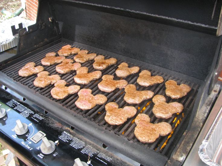 hamburger patties cooking on an outdoor grill