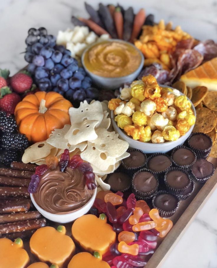 a platter filled with candy, candies and fruit