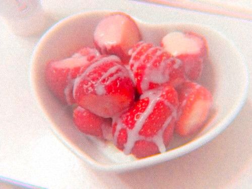 some strawberries are in a white bowl