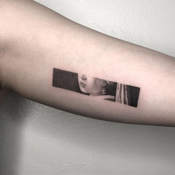 a woman's arm with a black and white photo on the left side of her arm