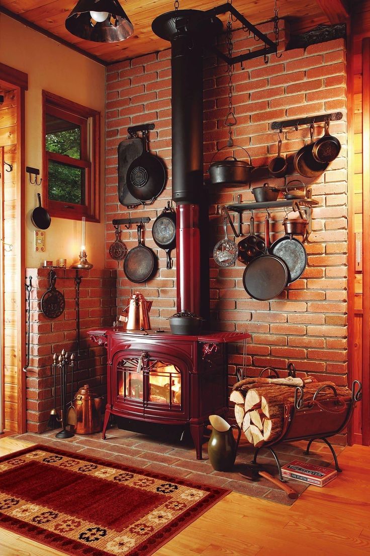 an old fashioned stove in the corner of a room with pots and pans hanging on the wall