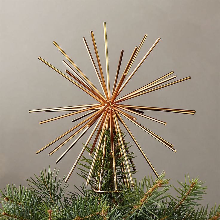 a christmas tree topper made out of sticks