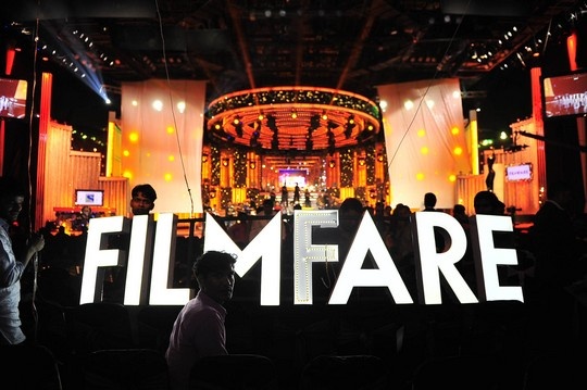 people standing in front of a stage with the words filmfare lit up on it