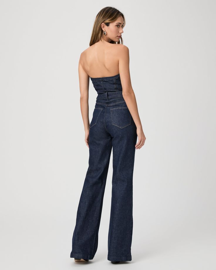 The must have one-piece of the season. Inspired by our Leenah wide leg silhouette, this strapless jumpsuit is crafted from super soft dark wash denim with a hint of stretch for comfort and features silver front buttons, elastic at the back, and light boning in the bodice. The Sansa Jumpsuit pairs perfectly with boots, heels, or flats. | Sansa Jumpsuit - Calix Blue | Size 6 Denim Strapless Jumpsuit With High Waist, Strapless Fitted Denim Jumpsuits And Rompers, Fitted Denim Strapless Jumpsuits And Rompers, Strapless Fitted Denim Jumpsuits, Wide Leg Denim Strapless Jumpsuit, Chic Denim Blue Wide Leg Jumpsuits And Rompers, Strapless Wide Leg Denim Jumpsuit, Chic Strapless Denim Jumpsuits And Rompers, Chic High Rise Strapless Jumpsuit For Summer