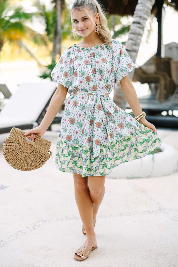 This floral dress is so cute and easy to wear! It's the perfect combination of classy and casual. Which means you can dress this beauty up with heels or down with sandals. Round neckline Short sleeves Tied waist Dual floral print No stretch Poppy is wearing the small. Vacation Dresses With Tie Waist For Spring, Summer Dress With Tie Waist For Garden Party, Summer Tropical Print Floral Dress For Garden Party, Summer Floral Dress With Tropical Print For Garden Party, Spring Vacation Mini Dress With Tie Waist, Chic Ditsy Floral Print Dress For Brunch, Summer Tropical Print Floral Dress For Day Out, Summer Floral Dress With Tropical Print For Brunch, Casual Floral Print Mini Dress For Summer Outings