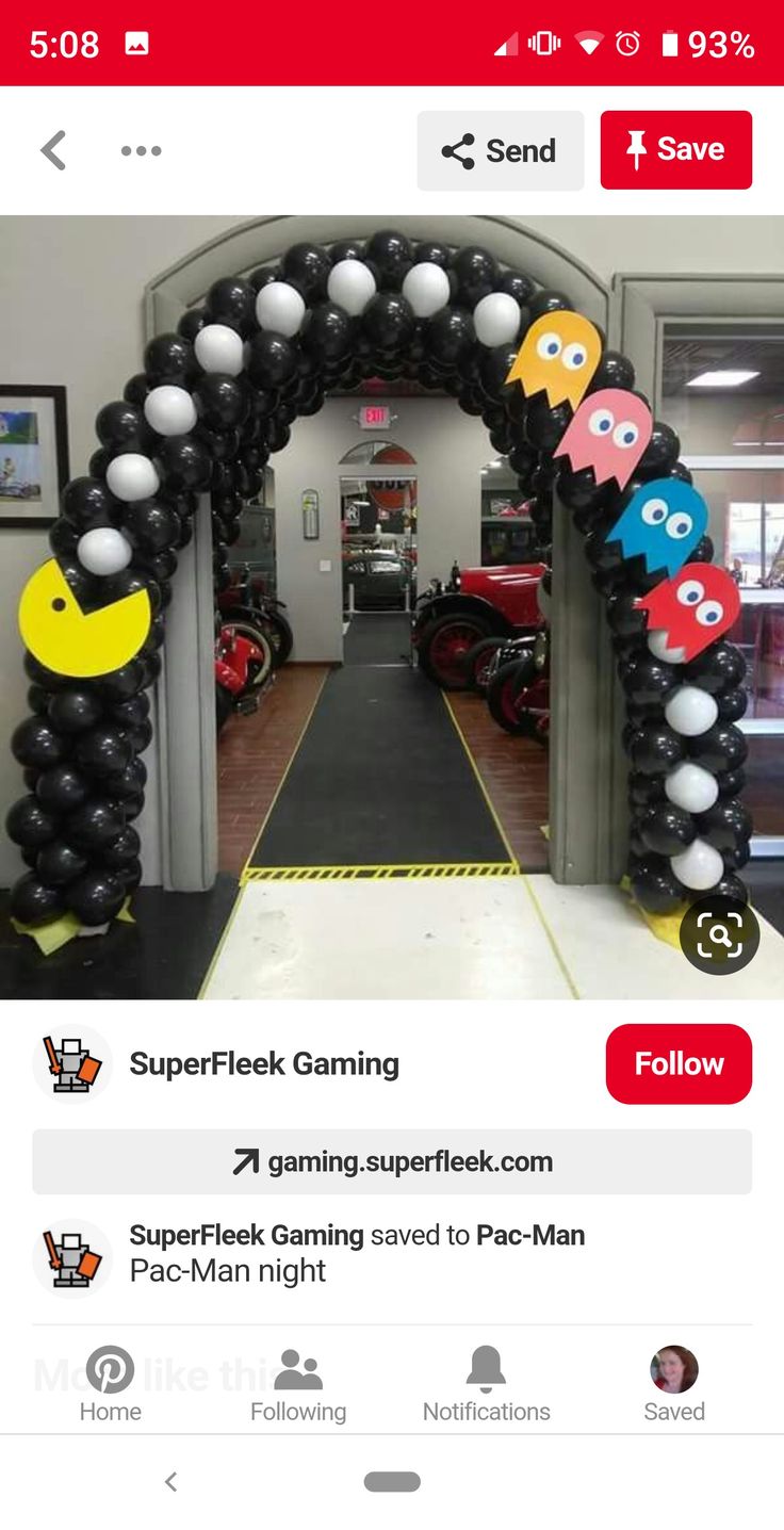 an arch made out of black and white balloons with pac - man characters on it