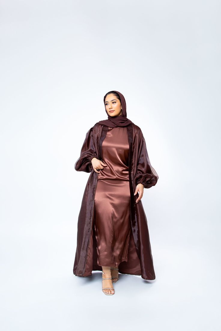 The Organza Abaya is statement outfit for any event. It's super lightweight yet so simple with the prettiest sheen. Complete the look with our matching long sleeve satin slip dress and a pair of strappy heels for a luxe finish or make it into a more casual look. *Please note that the color displayed in the picture might be slightly different due to the color resolution and lighting. Fabric Description & Care: Balloon Sleeves with elastic cuff Double Lined Material: Silk/Organza Dry Clean for bes Silk Long Abaya For Party, Silk Party Abaya, Elegant Silk Abaya For Eid, Satin Evening Abaya For Eid, Eid Evening Satin Abaya, Elegant Silk Abaya With Long Sleeves, Elegant Silk Abaya For Party, Elegant Long Sleeve Silk Abaya, Silk Long Sleeve Abaya For Party