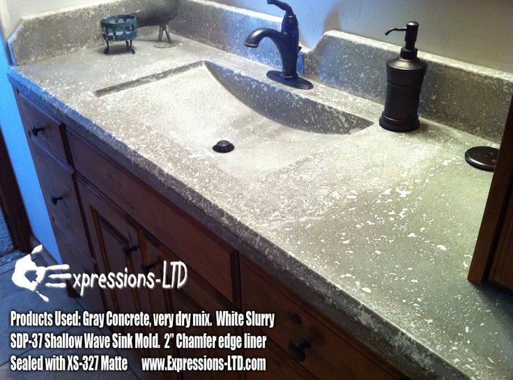 a bathroom sink with two faucets and soap dispenser