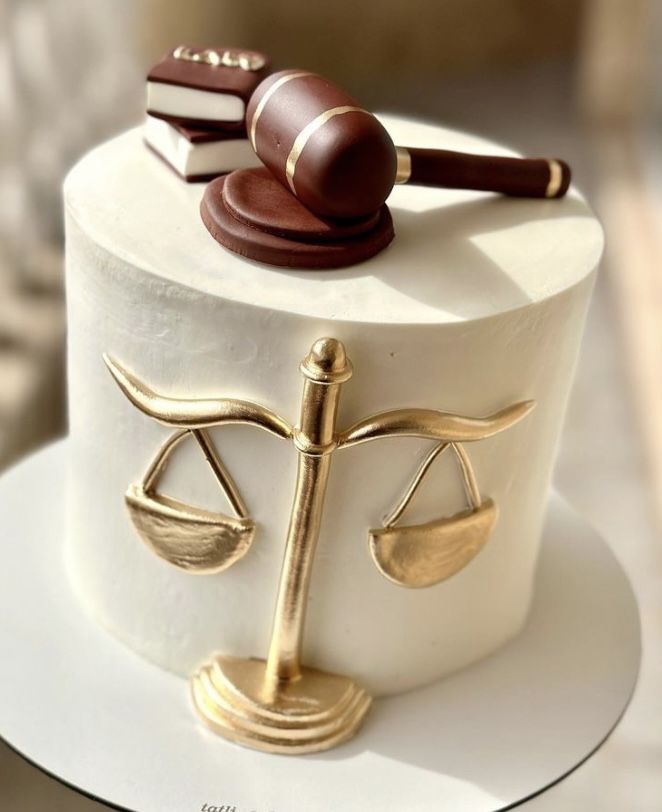 a cake with a judge's scale and book on top