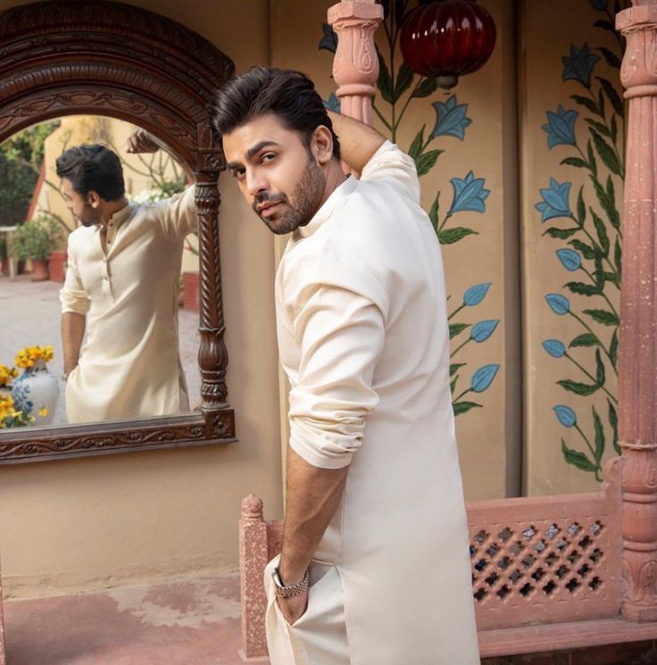 a man standing in front of a mirror