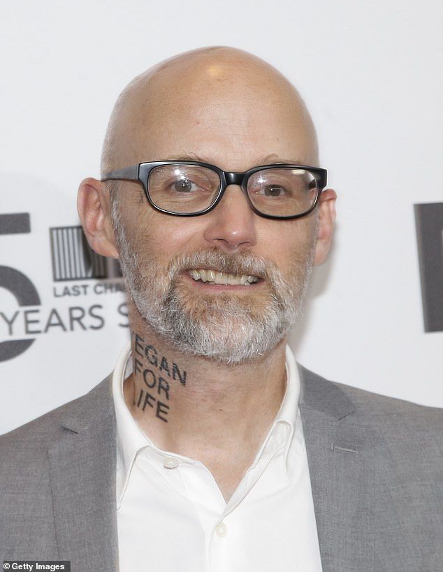 a bald man with glasses and tattoos on his face