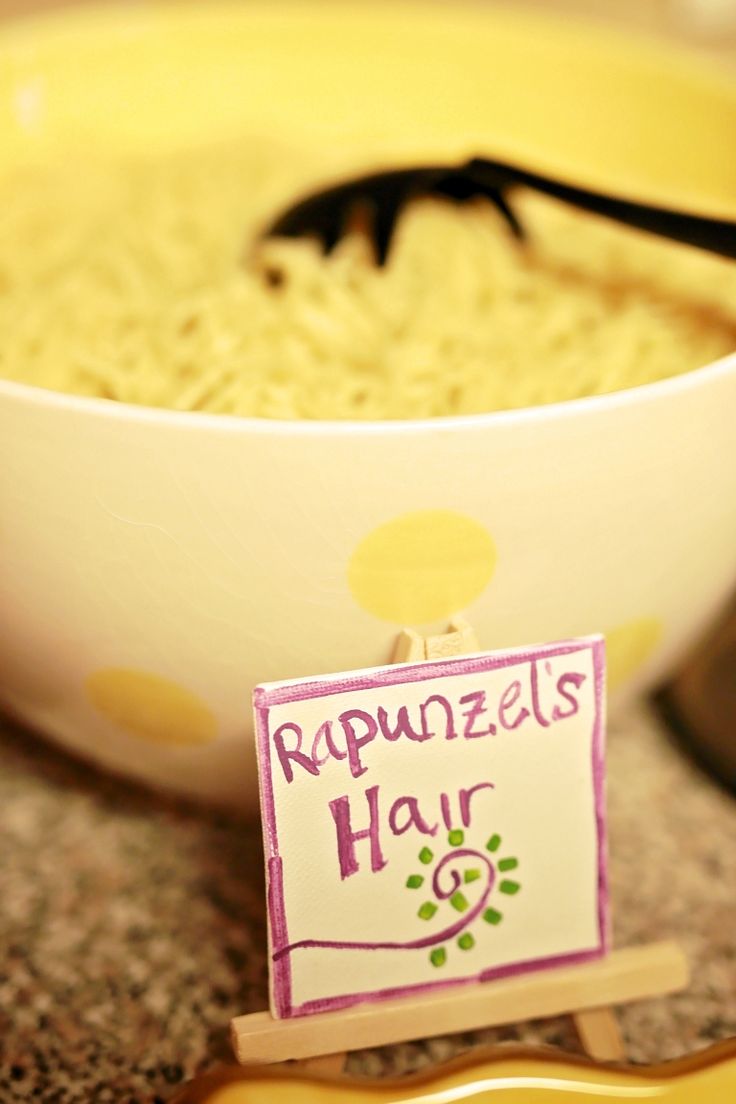 a bowl of oatmeal with a sign that reads rupnzels hair