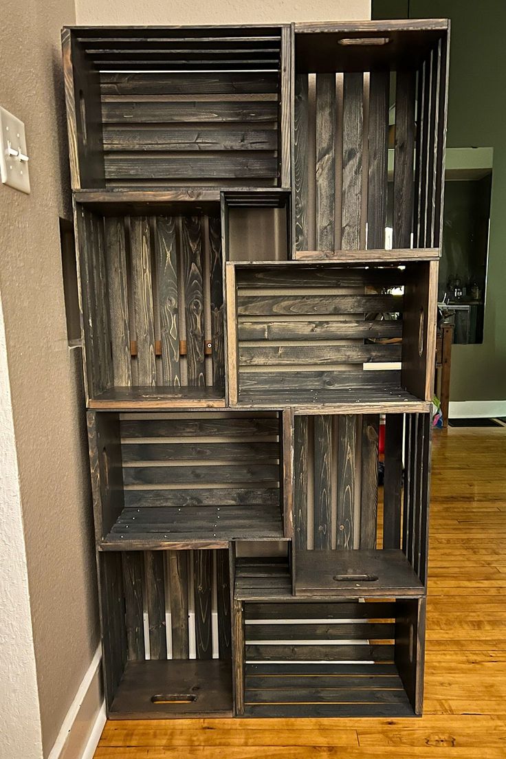 an old wooden bookcase with many compartments on it in a room that has hard wood flooring