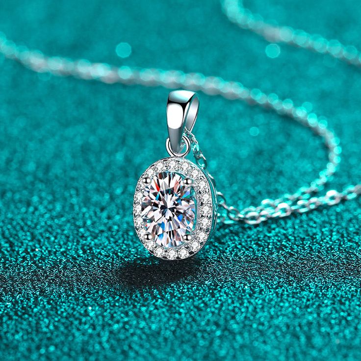 Click Here to check the discounted SET - earrings and necklace. Indulge in luxury with our Oval Cut Halo 1 Carat Moissanite Pendant. Adorned with a shimmering halo and oval-cut stone, this platinum-plated necklace exudes sophistication and elegance. The S925 chain adds a touch of refinement. Elevate your style with this exclusive and timeless piece. GRA Certificate & Deluxe Gift Box included. Contact us if you want to customize your design. AZ653-X Timeless Necklace, Ghost Mannequin, Stone Properties, Moissanite Pendant, Oval Necklace, Moissanite Necklace, Round Pendant Necklace, Picture Style, Moissanite Jewelry